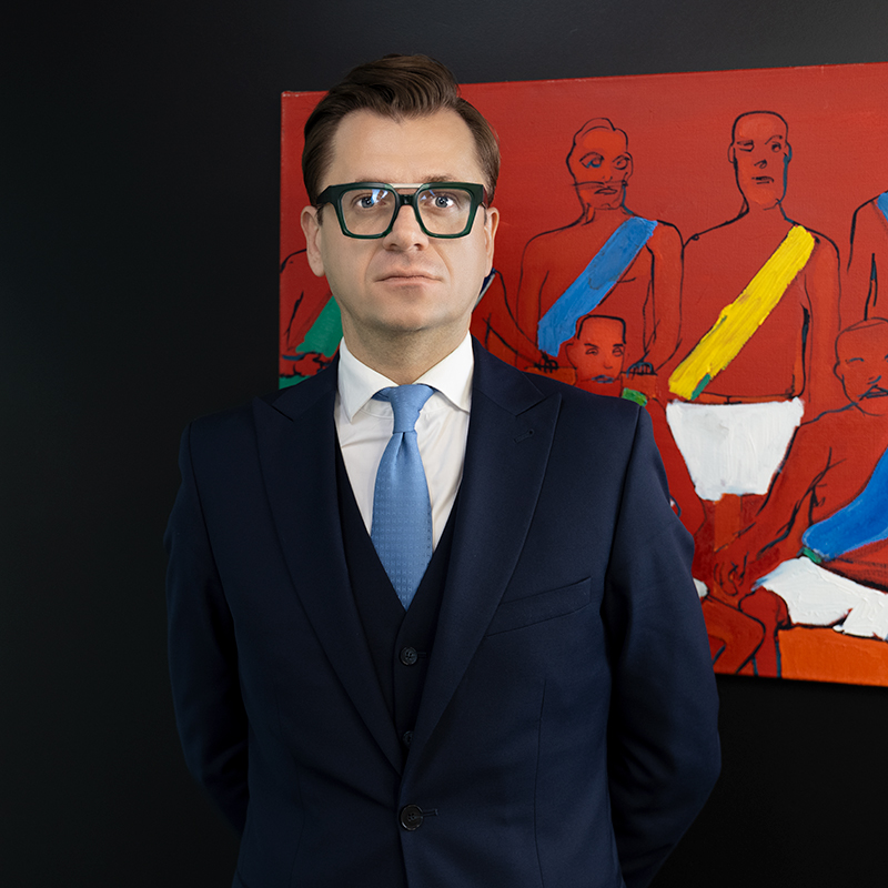 Paweł Wroński with art in his office